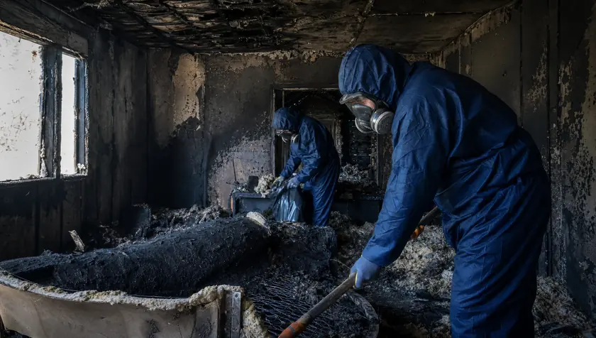 A soot-blackened, smoke-damaged room interior after a house fire.